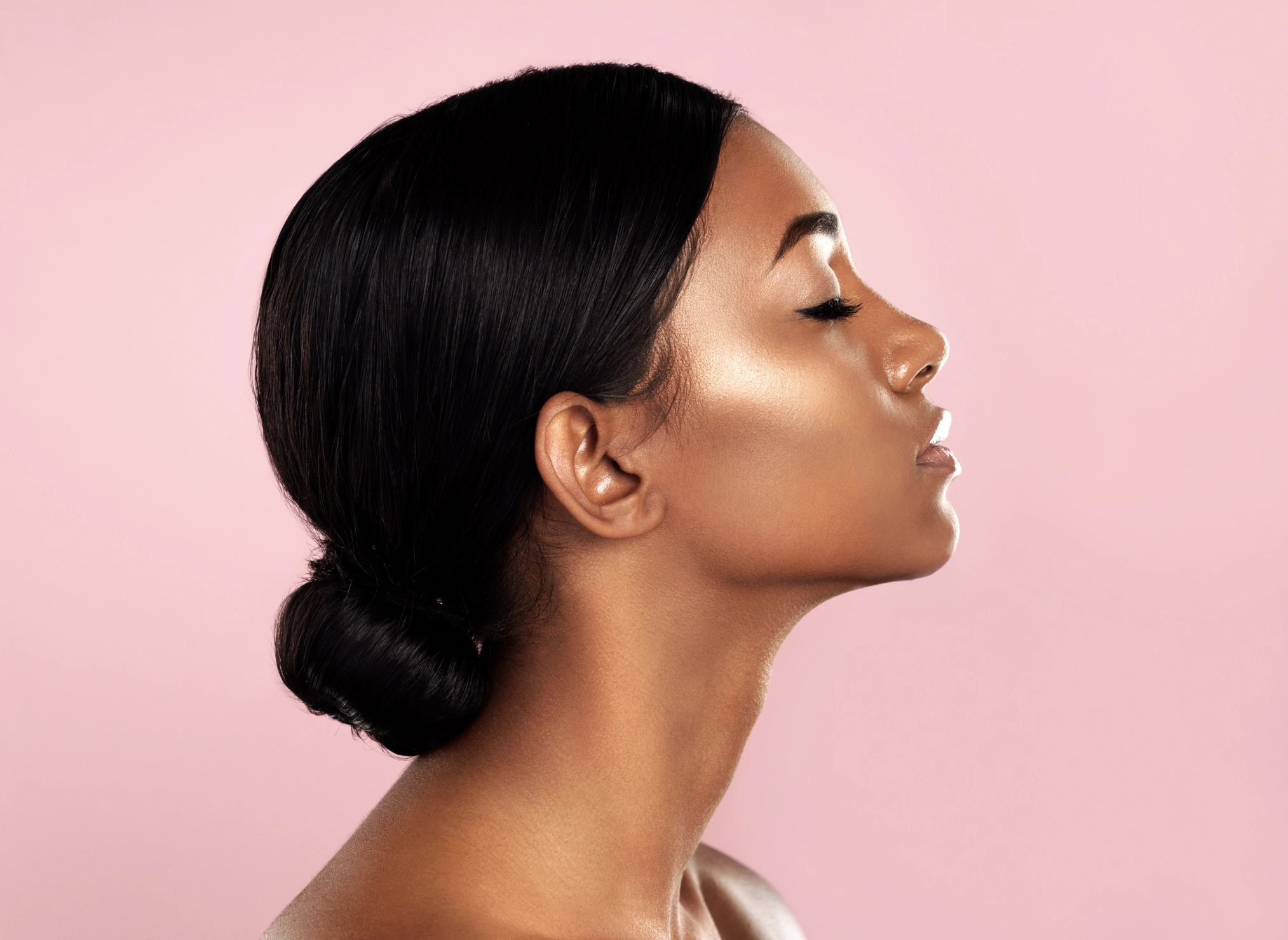 Woman in profile with polished editorial beauty styling