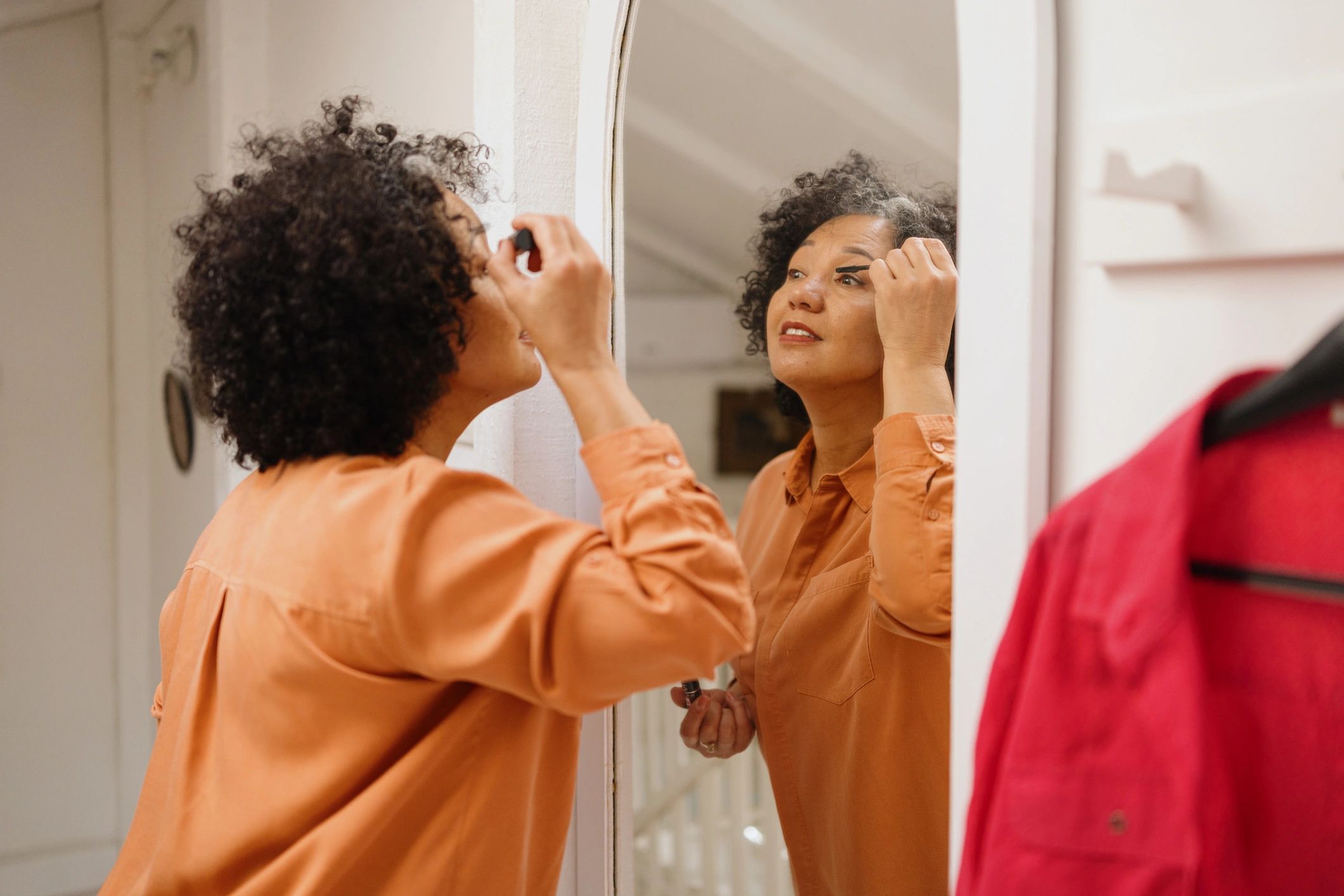 Woman applying mascara during a polished beauty routine